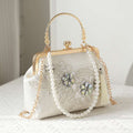 Handcrafted clutch embroidered with flowers decorated with zircons.