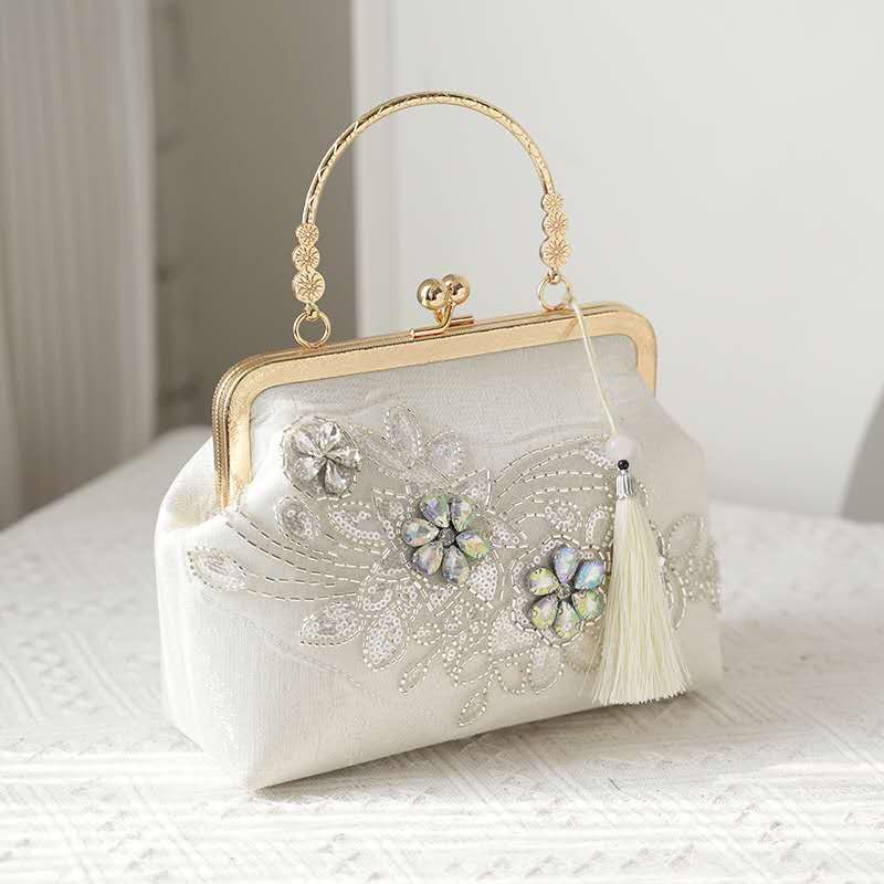 Handcrafted clutch embroidered with flowers decorated with zircons.