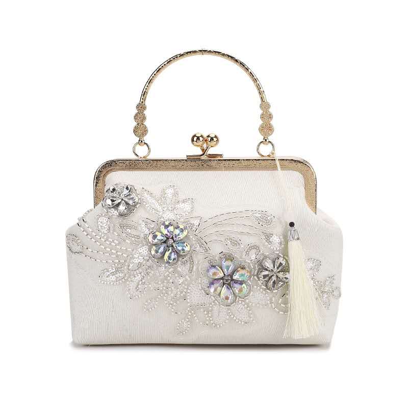 Handcrafted clutch embroidered with flowers decorated with zircons.