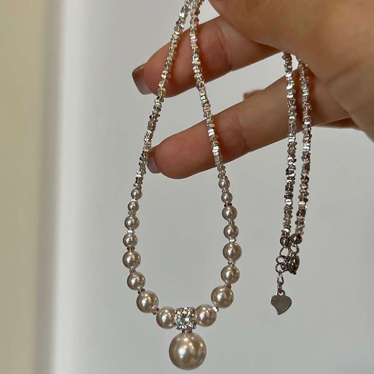 Necklace with crushed silver granules and irregular pearls