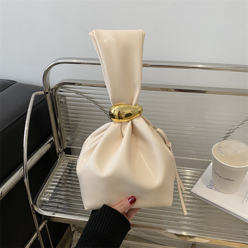 New women's retro pleated bag: a stylish, minimalist, and unique bucket bag featuring a spacious interior and an elegant aesthetic.