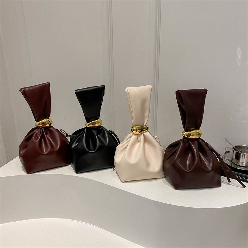 New women's retro pleated bag: a stylish, minimalist, and unique bucket bag featuring a spacious interior and an elegant aesthetic.