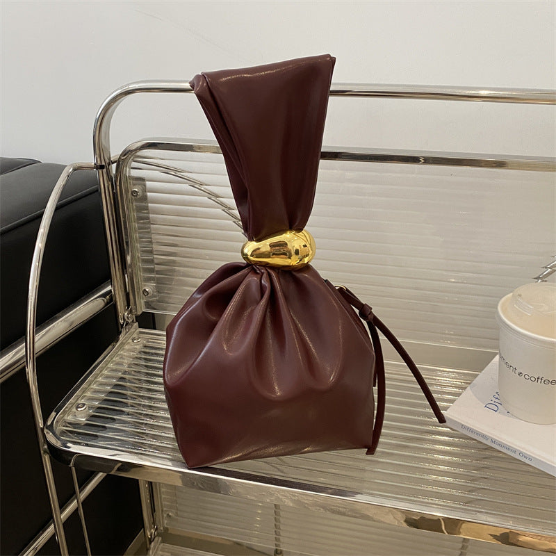 New women's retro pleated bag: a stylish, minimalist, and unique bucket bag featuring a spacious interior and an elegant aesthetic.