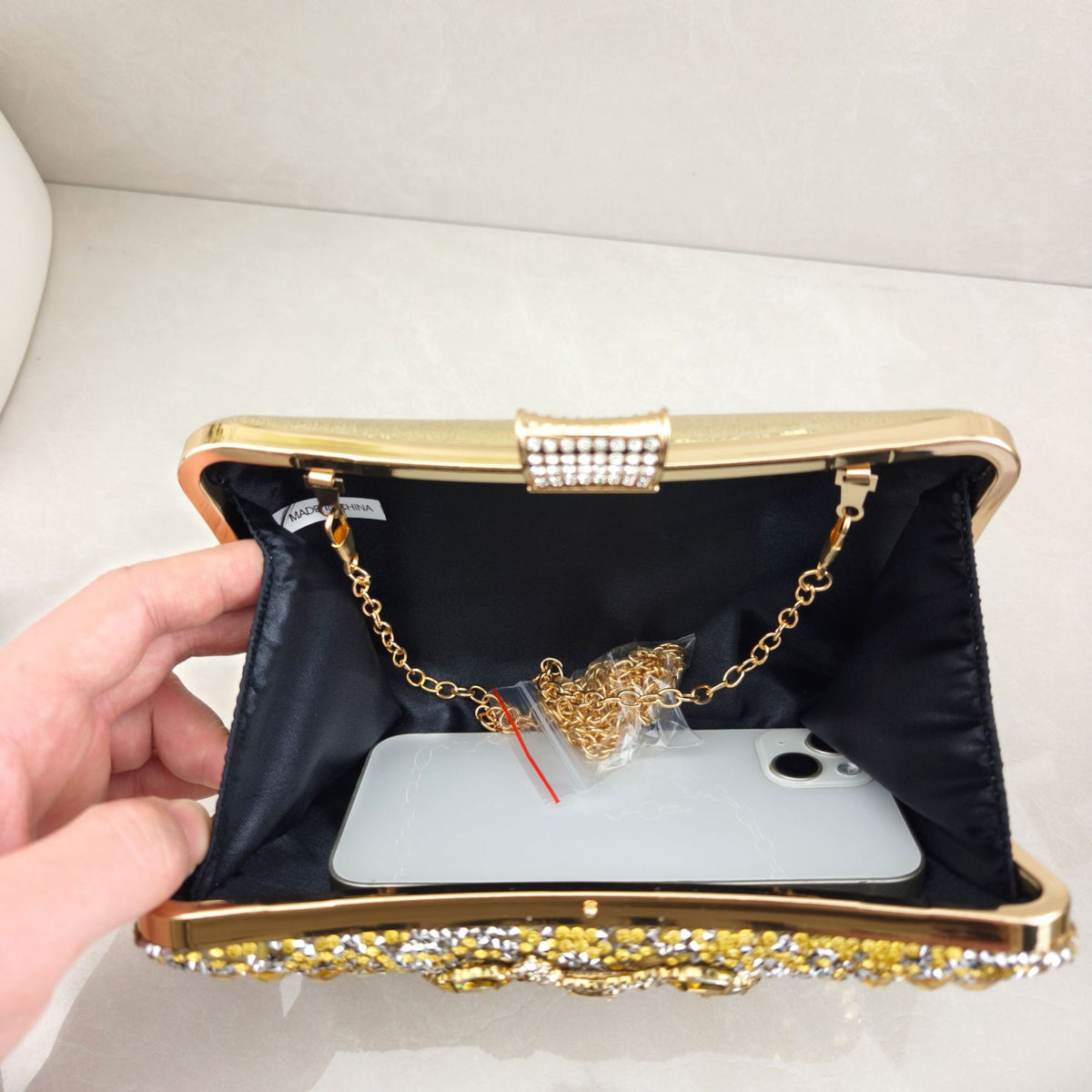 Rhinestone-embellished evening bag—a small, structured handbag/clutch suitable for formal events, featuring options for handheld, crossbody, or clutch carry.