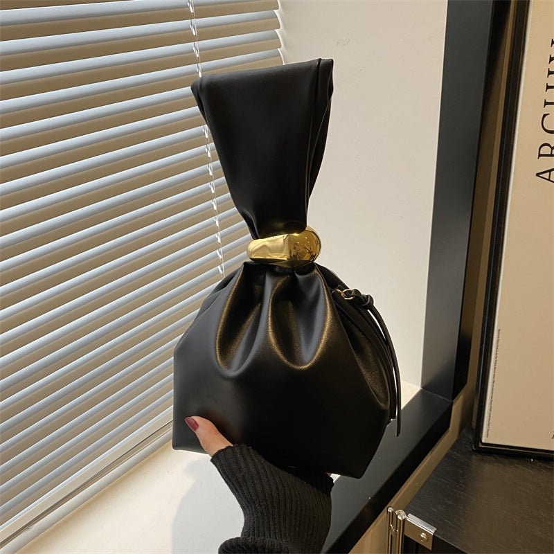 New women's retro pleated bag: a stylish, minimalist, and unique bucket bag featuring a spacious interior and an elegant aesthetic.