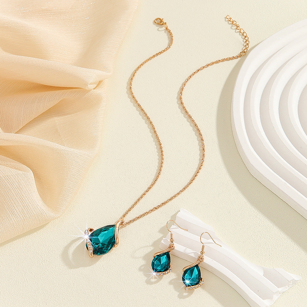 Parure de bijoux comprenant un collier avec pendentif en forme de goutte d'eau en cristal bleu et des boucles d'oreilles pendantes, en alliage de zinc hypoallergénique