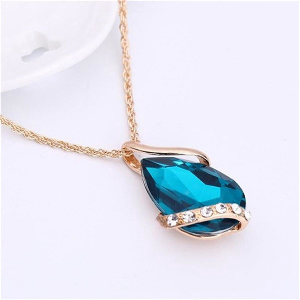 Parure de bijoux comprenant un collier avec pendentif en forme de goutte d'eau en cristal bleu et des boucles d'oreilles pendantes, en alliage de zinc hypoallergénique