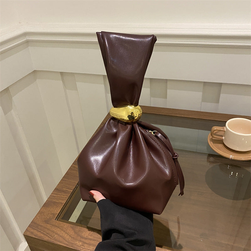 New women's retro pleated bag: a stylish, minimalist, and unique bucket bag featuring a spacious interior and an elegant aesthetic.