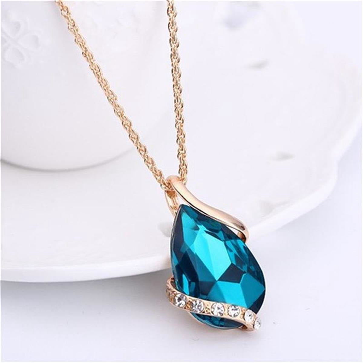 Parure de bijoux comprenant un collier avec pendentif en forme de goutte d'eau en cristal bleu et des boucles d'oreilles pendantes, en alliage de zinc hypoallergénique