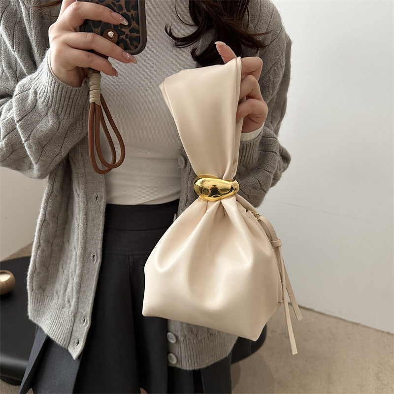 New women's retro pleated bag: a stylish, minimalist, and unique bucket bag featuring a spacious interior and an elegant aesthetic.