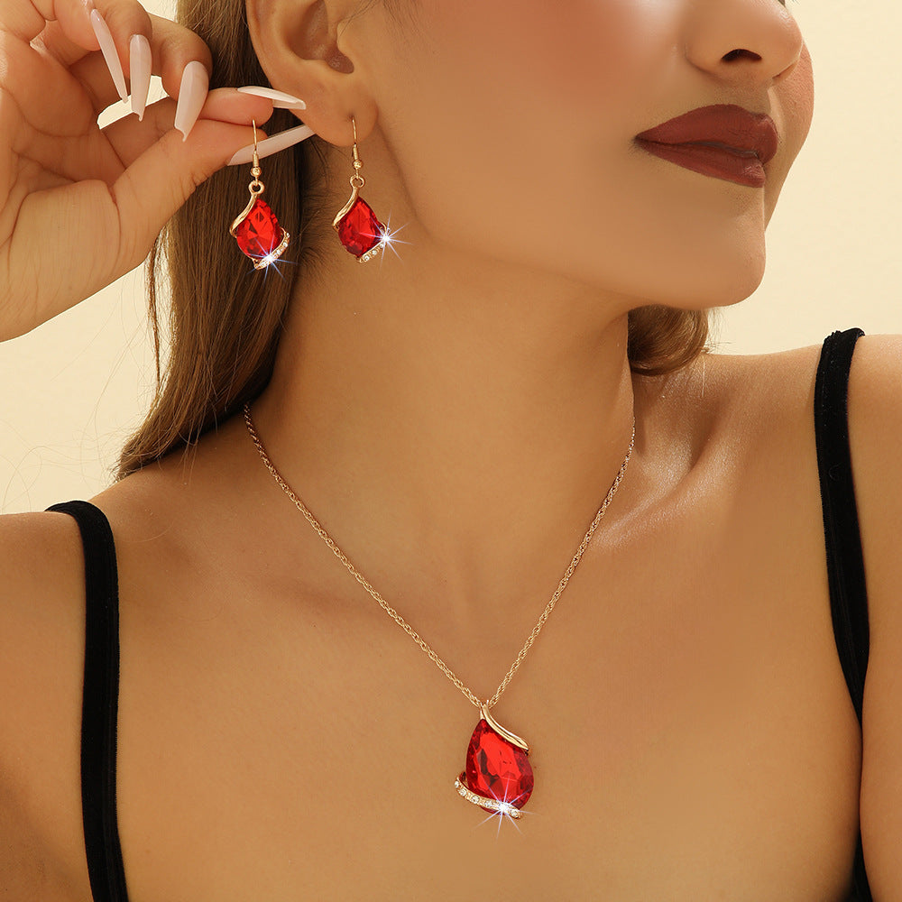 Parure de bijoux comprenant un collier avec pendentif en forme de goutte d'eau en cristal bleu et des boucles d'oreilles pendantes, en alliage de zinc hypoallergénique